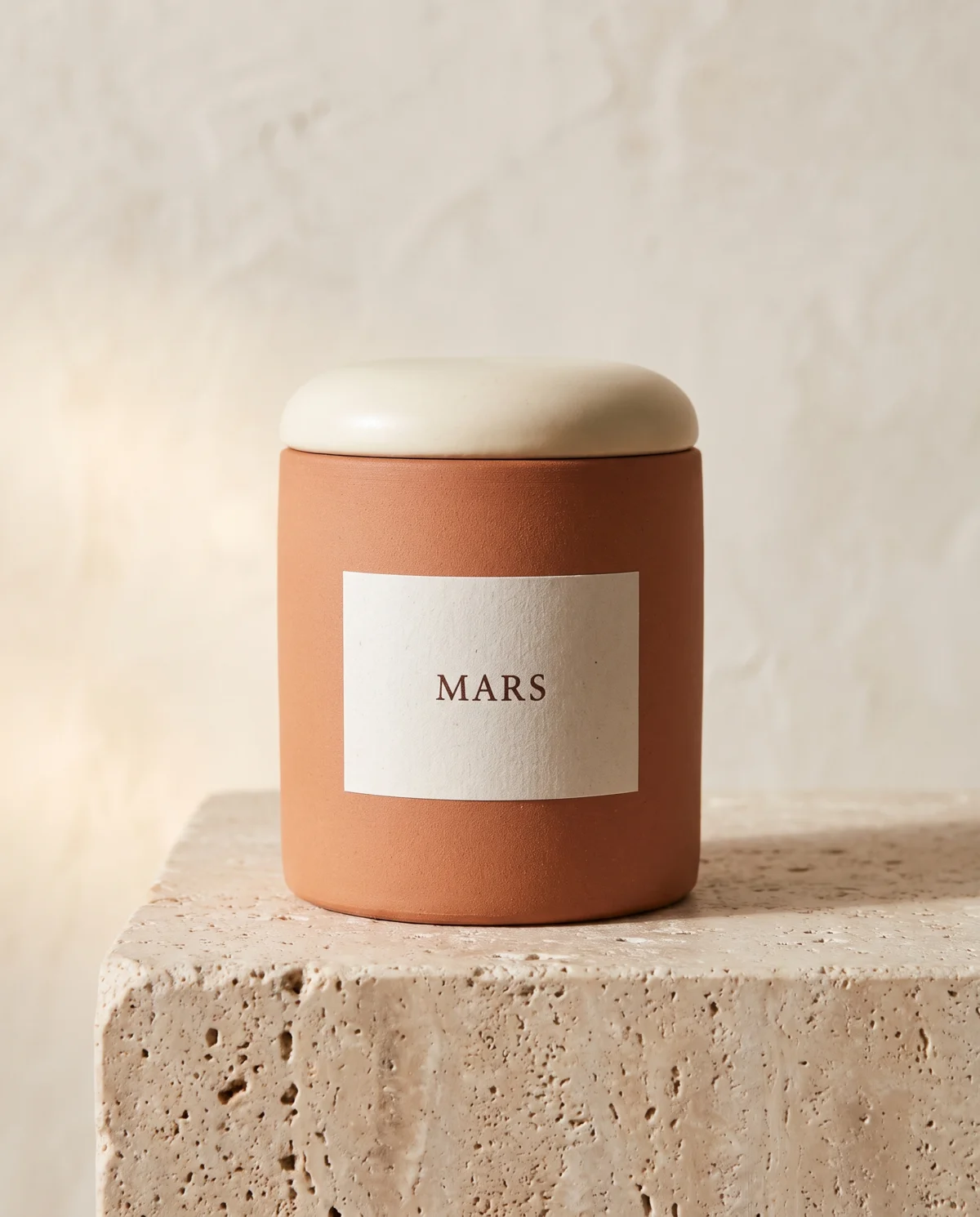 Jar of Mars Australia Group Sculpting Clay on a travertine plinth against cream limewash